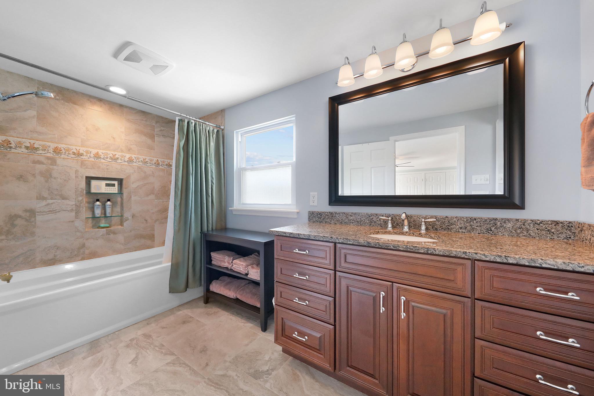 716 Liberty Road Mount Laurel, NJ 08054 - Photo 25 of 51 a bathroom with a granite countertop double vanity sink a mirror and a bathtub