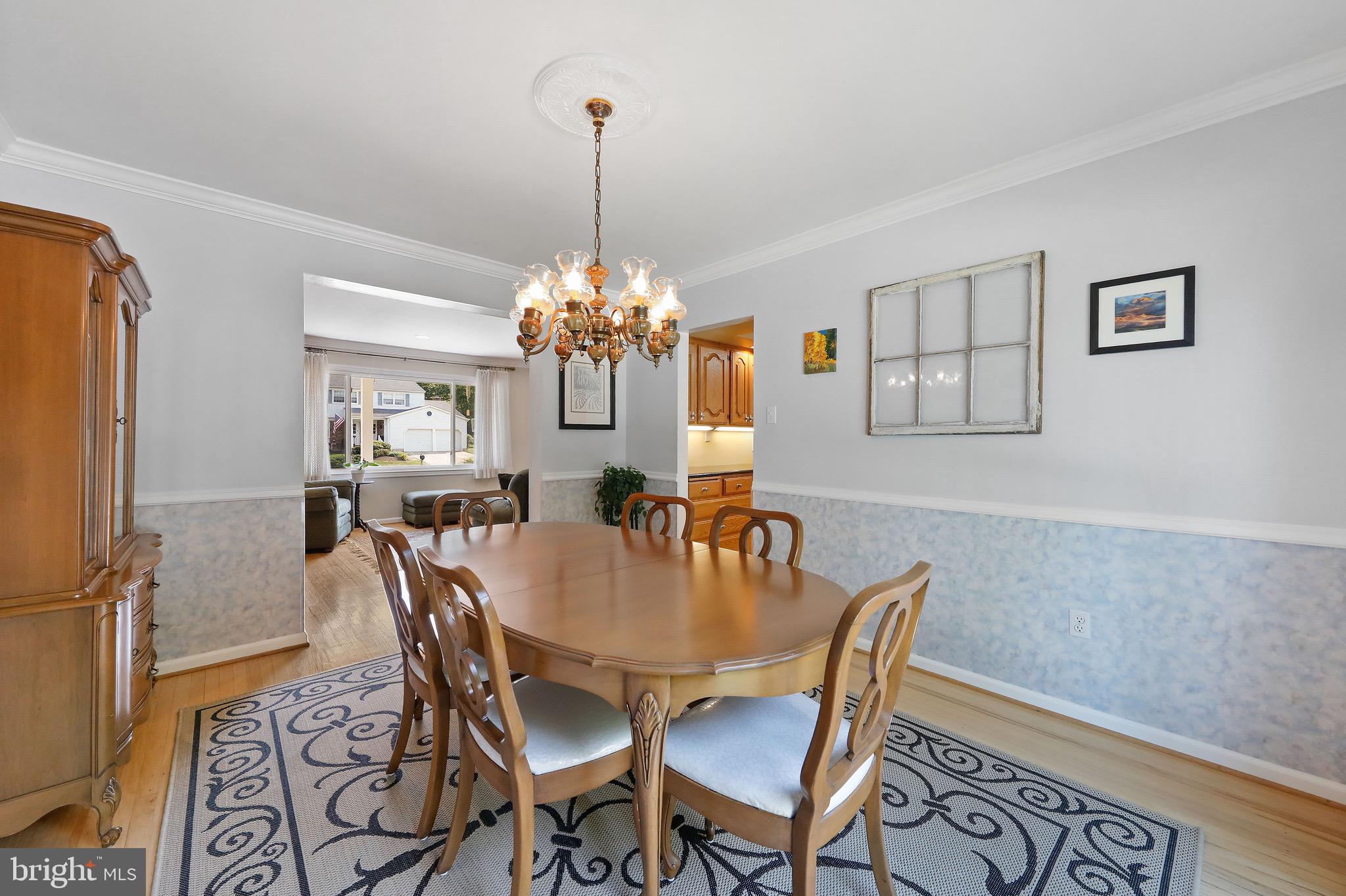 716 Liberty Road Mount Laurel, NJ 08054 - Photo 6 of 51 a view of a dining room with furniture a chandelier and wooden floor