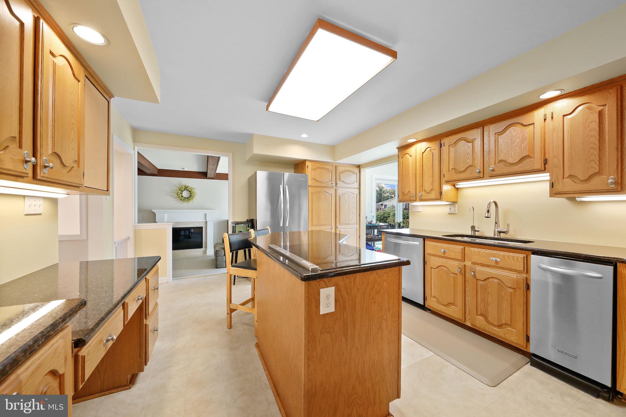 716 Liberty Road Mount Laurel, NJ 08054 - Photo 10 of 51 a kitchen with stainless steel appliances granite countertop a stove top oven a sink dishwasher and white cabinets with wooden floor