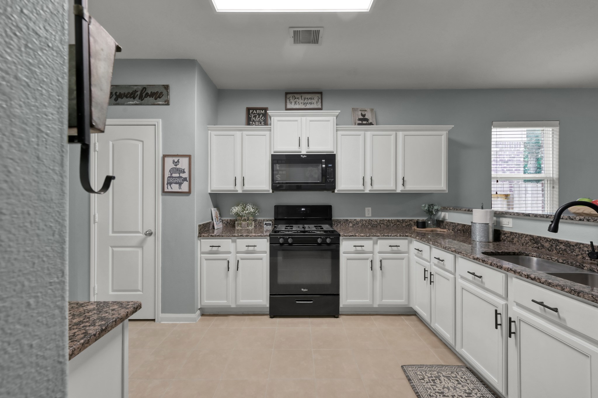 7562 Fettle Lane Conroe, TX 77304 - Photo 10 of 30 Functional kitchen with ample cabinetry, generous counter space, and open layout.