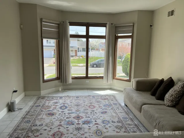 a living room with a couch and a window