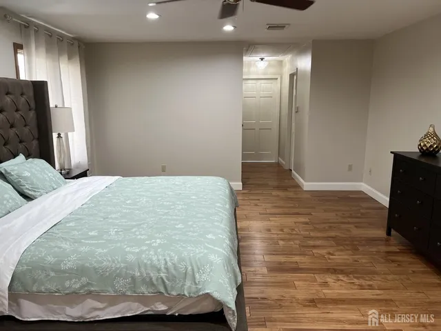a view of a livingroom with wooden floor and staircase