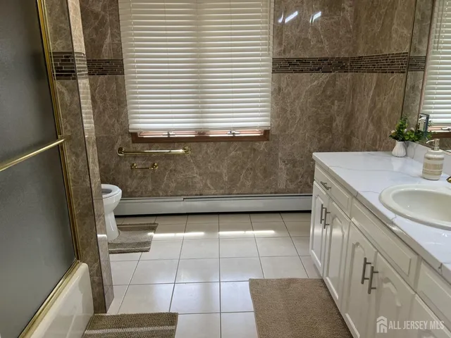 a bathroom with a sink a mirror and shower