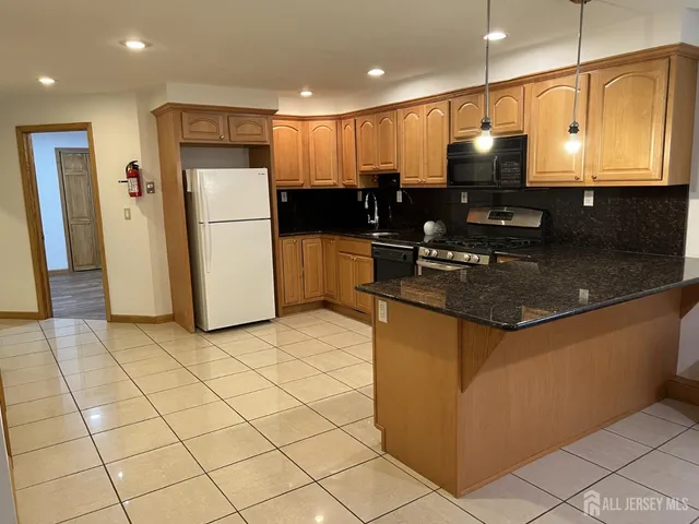 a kitchen with refrigerator and cabinets