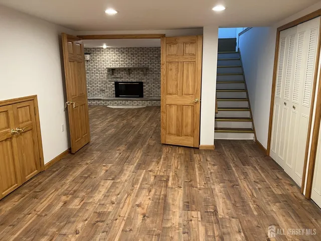 wooden floor in an empty room with a fireplace