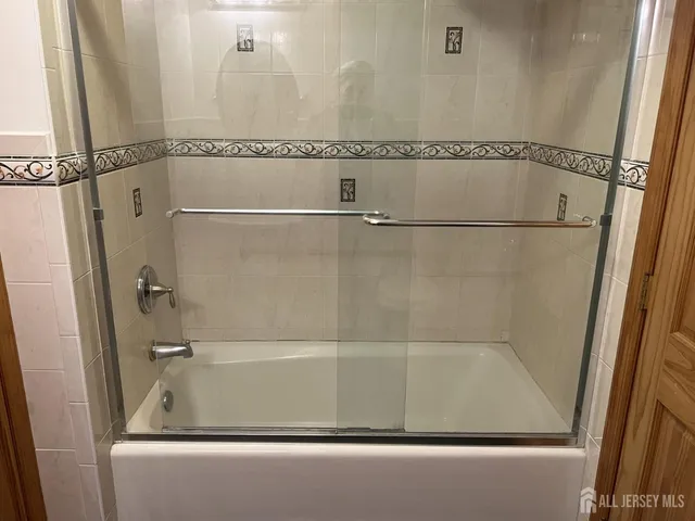 a bathroom with a bathtub and a shower