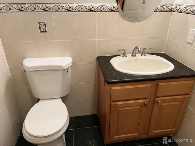 a bathroom with a toilet a sink and a mirror