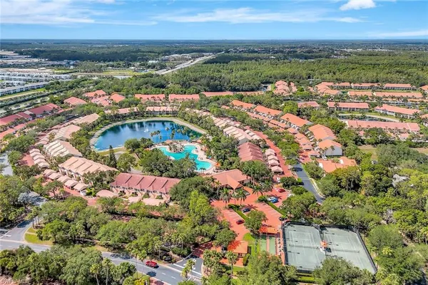 an aerial view of residential building and lake