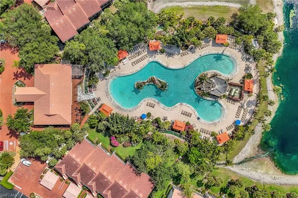 an aerial view of a swimming pool patio and outdoor seating