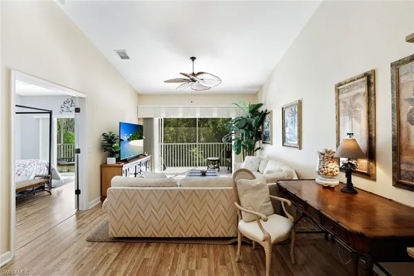 a living room with furniture dining table and a large window