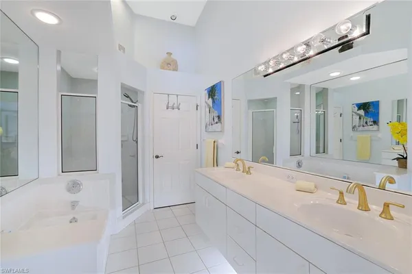 a bathroom with a tub sink and mirror