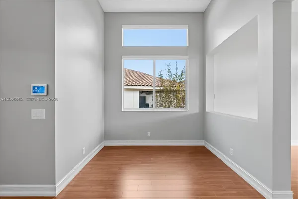 wooden floor in an empty room with a window