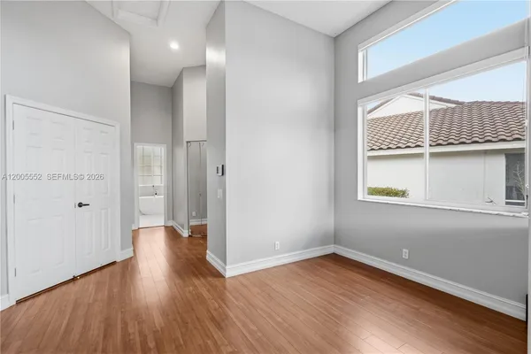 a view of a big room with wooden floor and closet