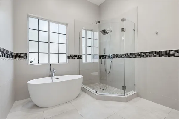 a view of a bathroom with a tub and sink