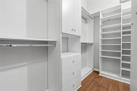 a view of walk in closet with empty racks