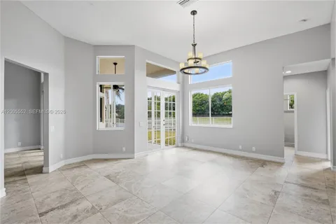 a large kitchen with stainless steel appliances kitchen island granite countertop a refrigerator and a stove top oven