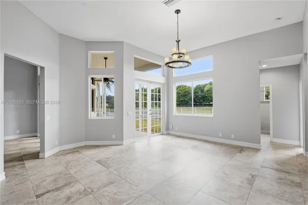 a large kitchen with stainless steel appliances kitchen island granite countertop a refrigerator and a stove top oven