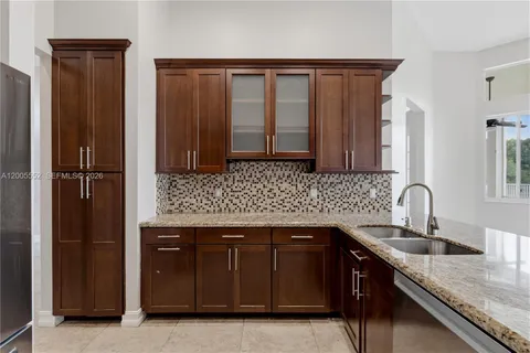 a kitchen with granite countertop cabinets and a stove top oven