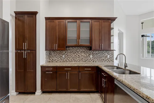 a kitchen with granite countertop cabinets and a stove top oven