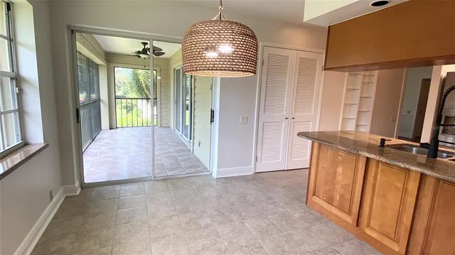 a view of a hallway with furniture and a window