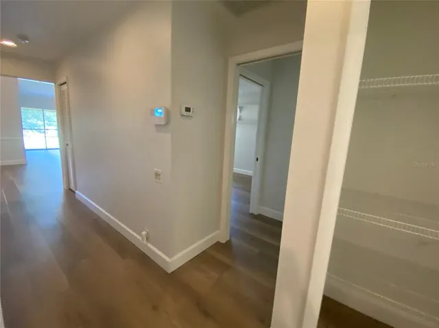 an empty room with wooden floor