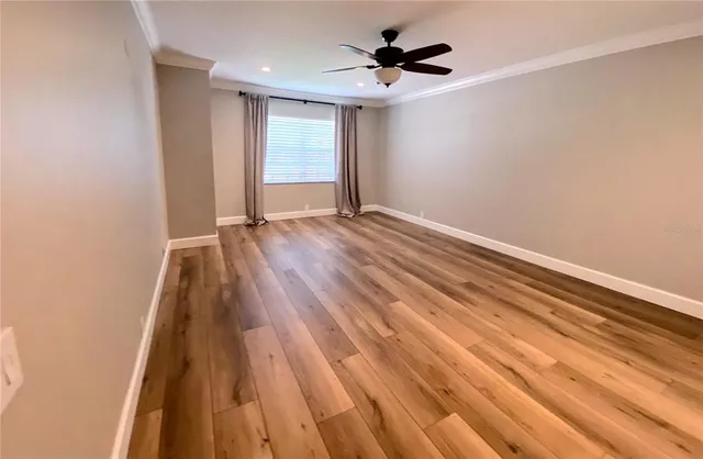 wooden floor in an empty room with a window