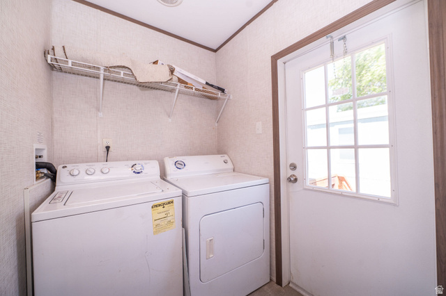 2491 Highway 89, Unit 403 Pleasant View, UT 84404 - Photo 20 of 32 Dedicated laundry area featuring a washer and dryer, an overhead wire shelving unit, and a windowed exterior door
