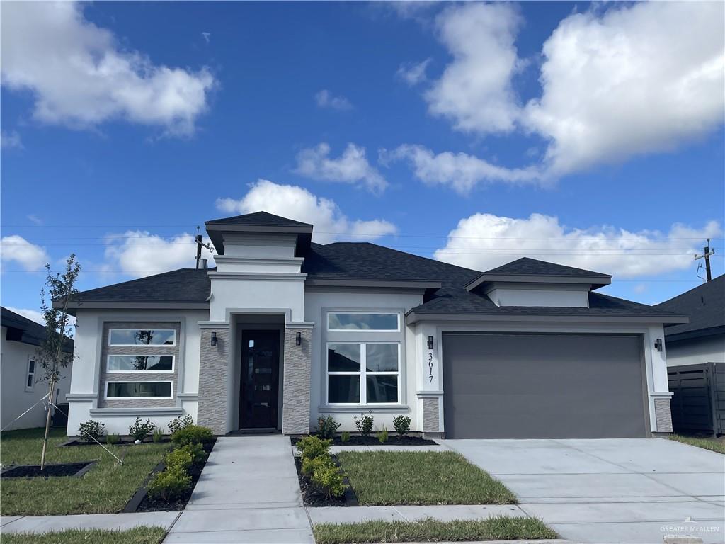a front view of a house with a yard and garage