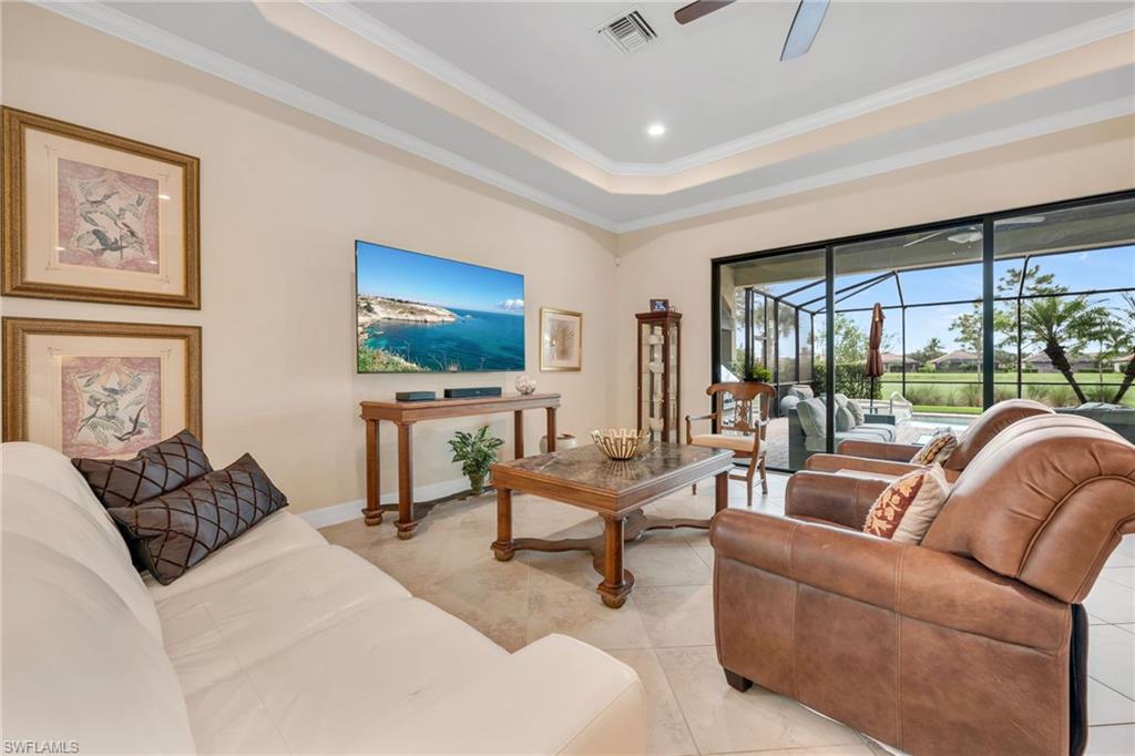 12740 Kinross Lane Naples, FL 34120 - Photo 11 of 32 a living room with furniture and a flat screen tv