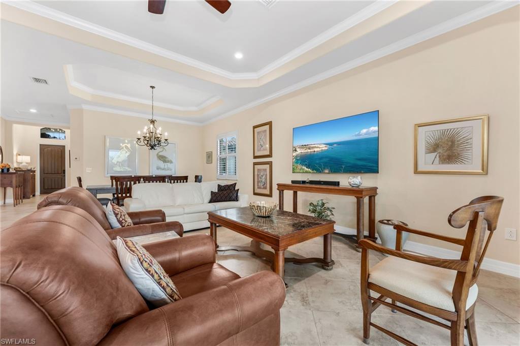 12740 Kinross Lane Naples, FL 34120 - Photo 12 of 32 a living room with furniture and a flat screen tv