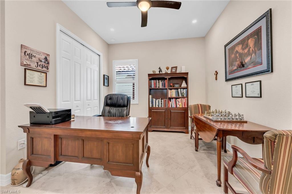 12740 Kinross Lane Naples, FL 34120 - Photo 16 of 32 a view of a workspace with furniture and a window