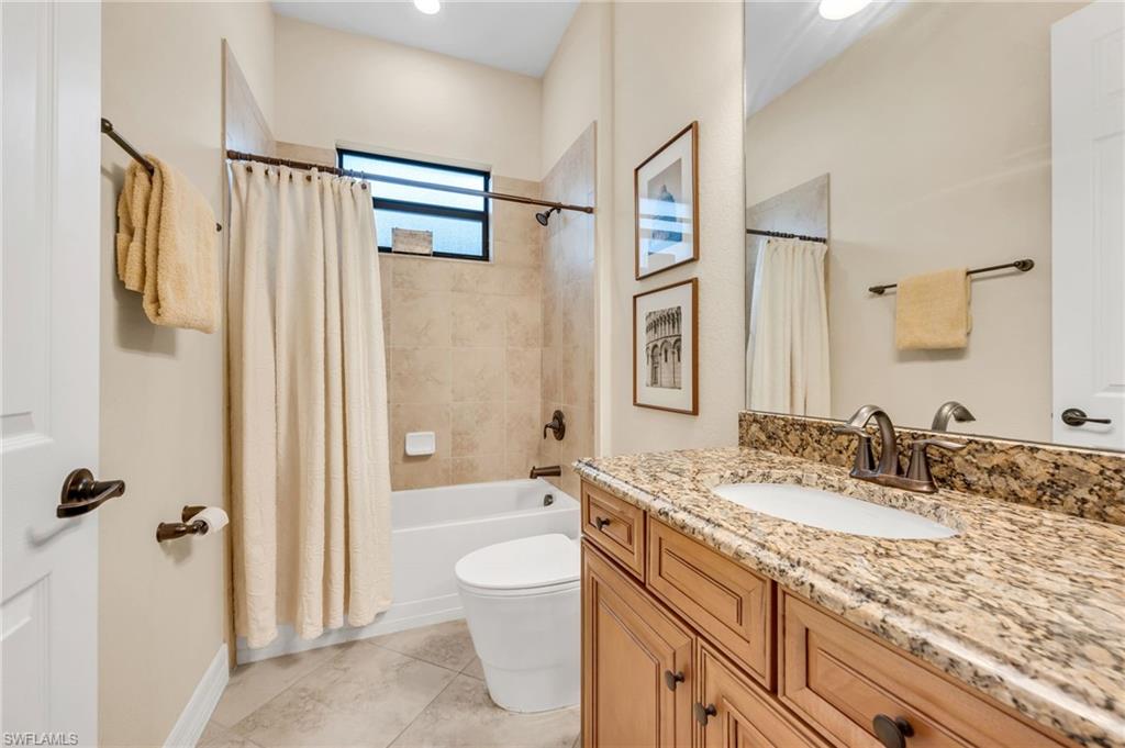 12740 Kinross Lane Naples, FL 34120 - Photo 20 of 32 a bathroom with a granite countertop sink toilet and shower