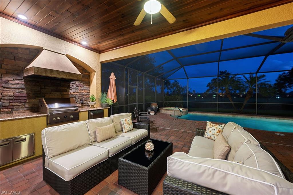 12740 Kinross Lane Naples, FL 34120 - Photo 2 of 32 a balcony with furniture and a fireplace