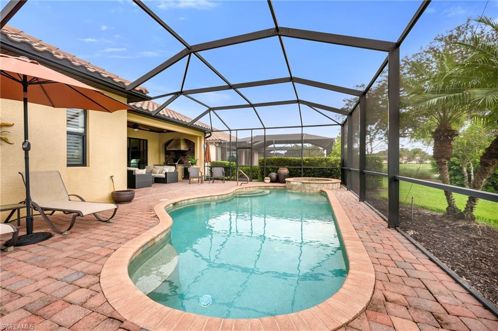 12740 Kinross Lane Naples, FL 34120 - Photo 7 of 32 a view of a swimming pool with a patio