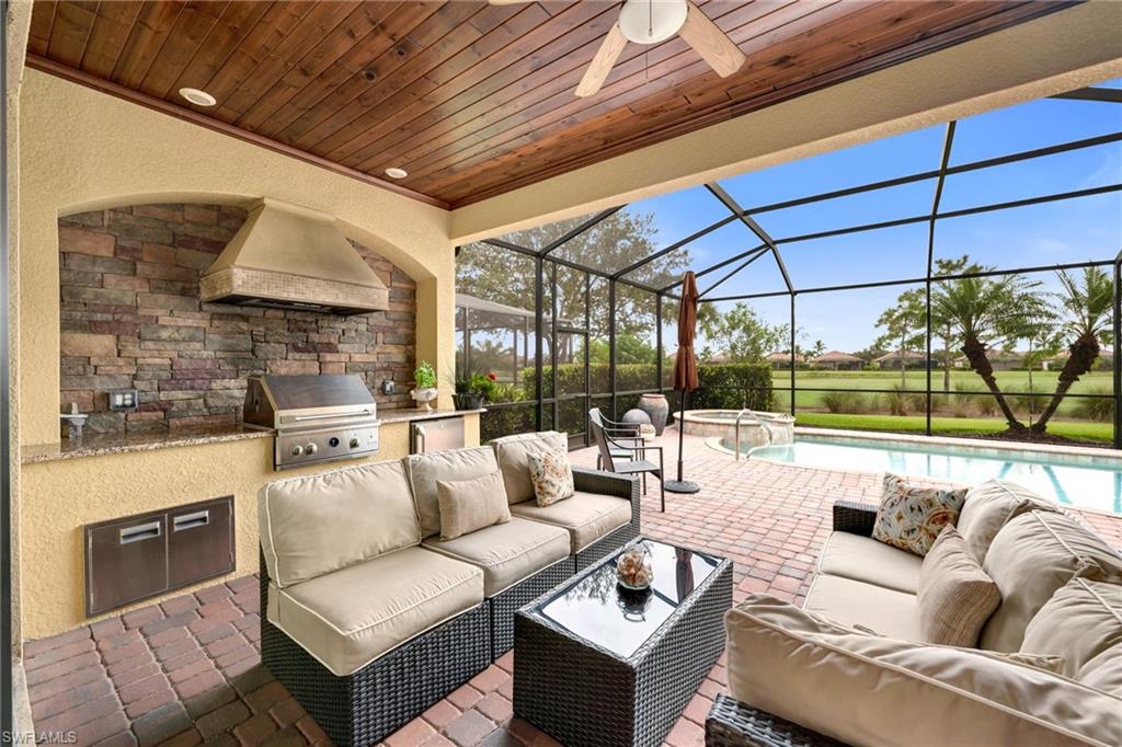 12740 Kinross Lane Naples, FL 34120 - Photo 8 of 32 a outdoor living space with patio furniture and a fireplace