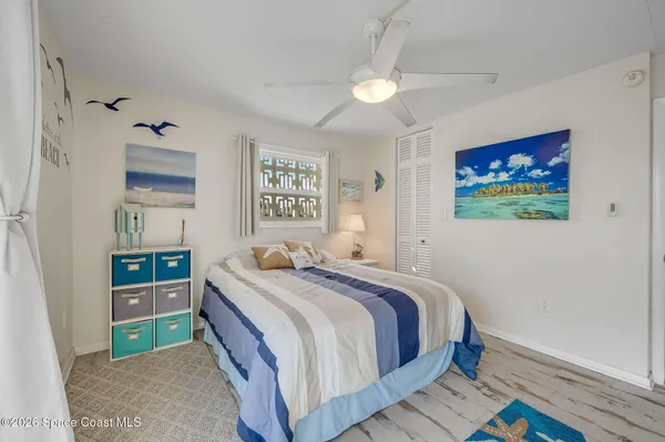 a bedroom with a bed and a painting on the wall