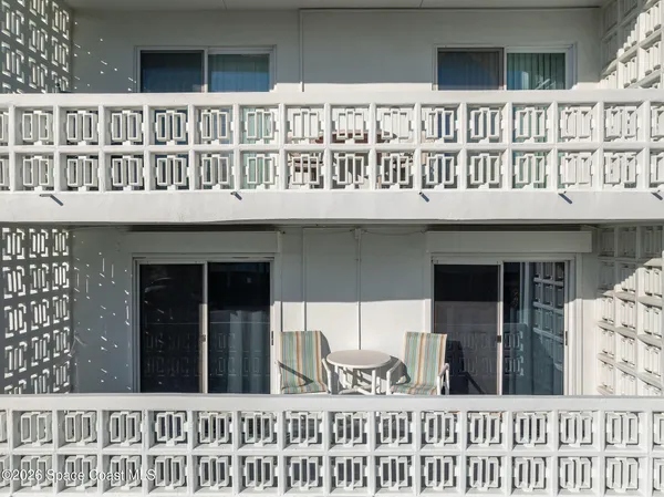 a view of a house with a wooden fence