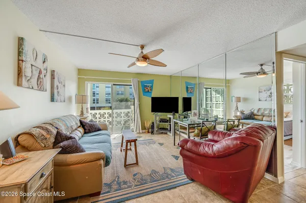 a living room with furniture a large window and a flat screen tv