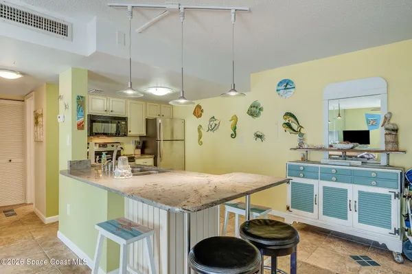 a kitchen with a table and chairs in it