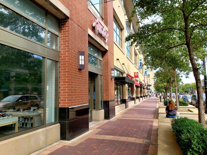807 Davis Street, Unit 1710 Evanston, IL 60201 - Photo 19 of 21 a street view with tall buildings and cars parked on road