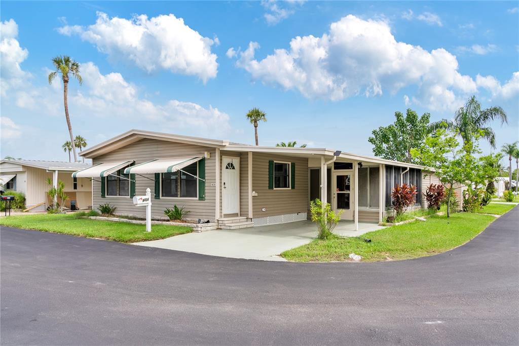 a front view of a house with a yard table and chairs