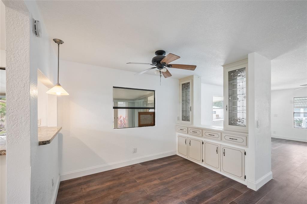 4434 Tucker Square New Port Richey, FL 34652 - Photo 12 of 37 a view of an empty room with a window and wooden floor