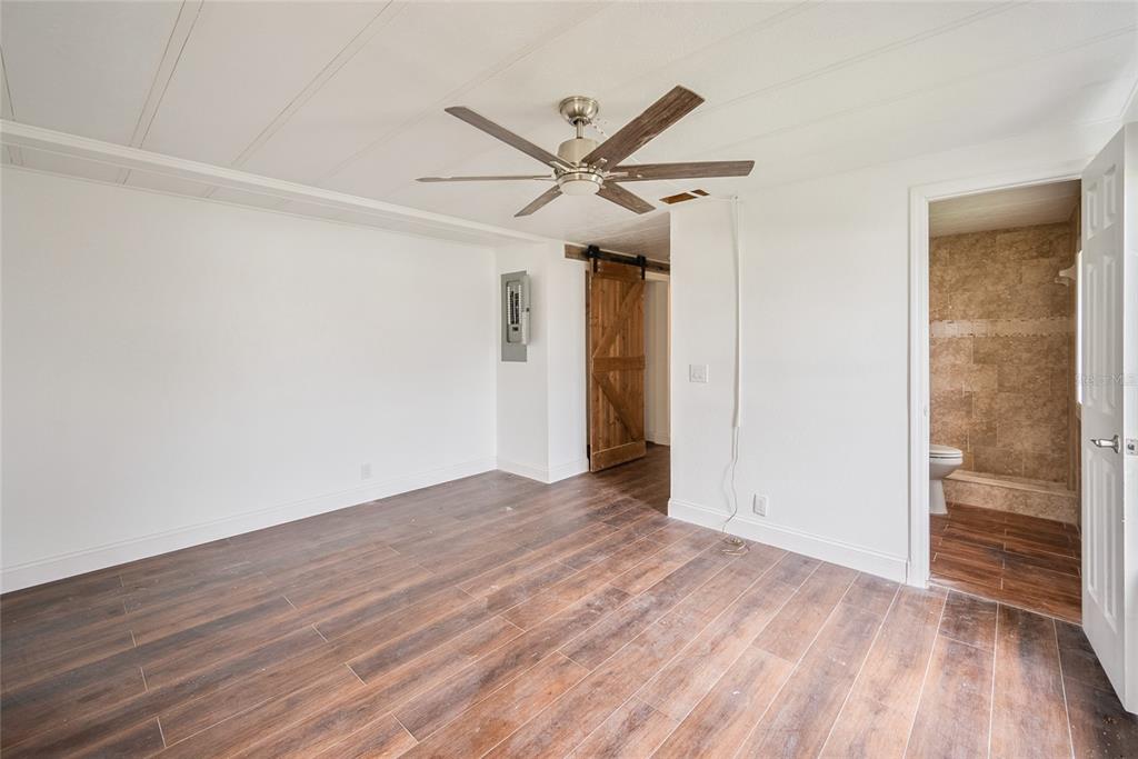 4434 Tucker Square New Port Richey, FL 34652 - Photo 15 of 37 a view of a livingroom with wooden floor and a ceiling fan