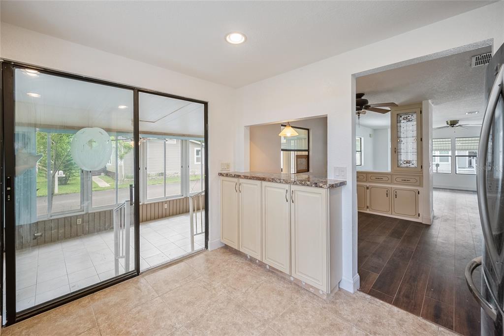 4434 Tucker Square New Port Richey, FL 34652 - Photo 7 of 37 a view of a hallway with wooden floor and a living room