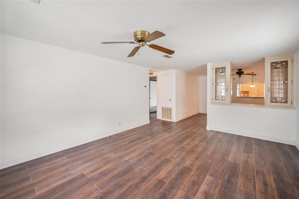 4434 Tucker Square New Port Richey, FL 34652 - Photo 9 of 37 a view of empty room with wooden floor and ceiling fan