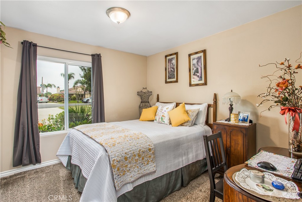 3396 Spring Garden Street Riverside, CA 92501 - Photo 15 of 28 a bedroom with a bed and a potted plant
