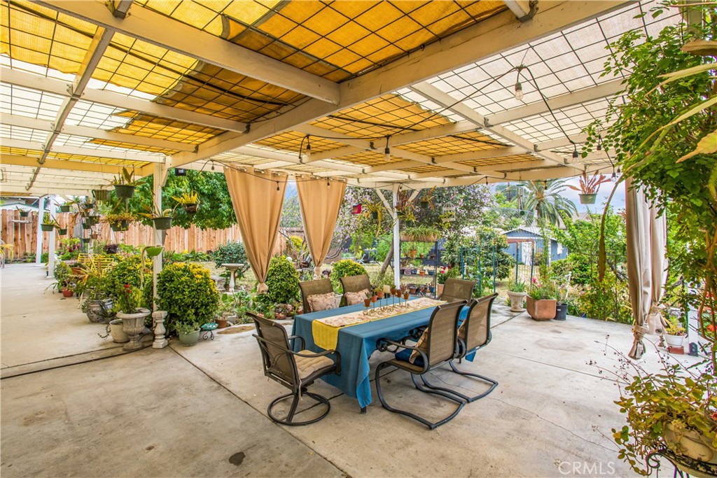 3396 Spring Garden Street Riverside, CA 92501 - Photo 21 of 28 a view of a patio with a table and chairs and potted plants