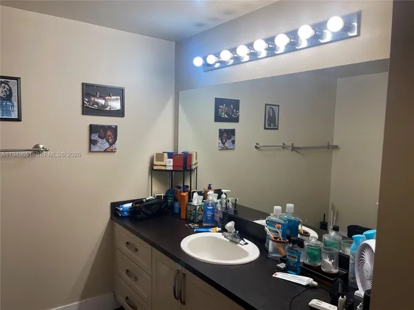 a bathroom with a sink vanity and a mirror
