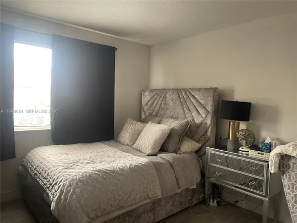 a bedroom with a bed and a tv