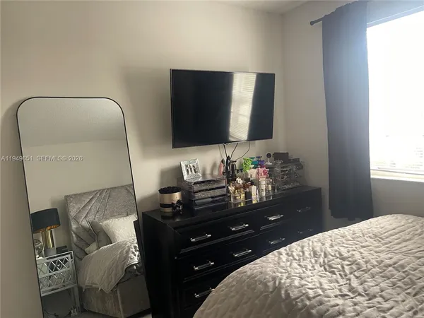 a living room with furniture and a lamp